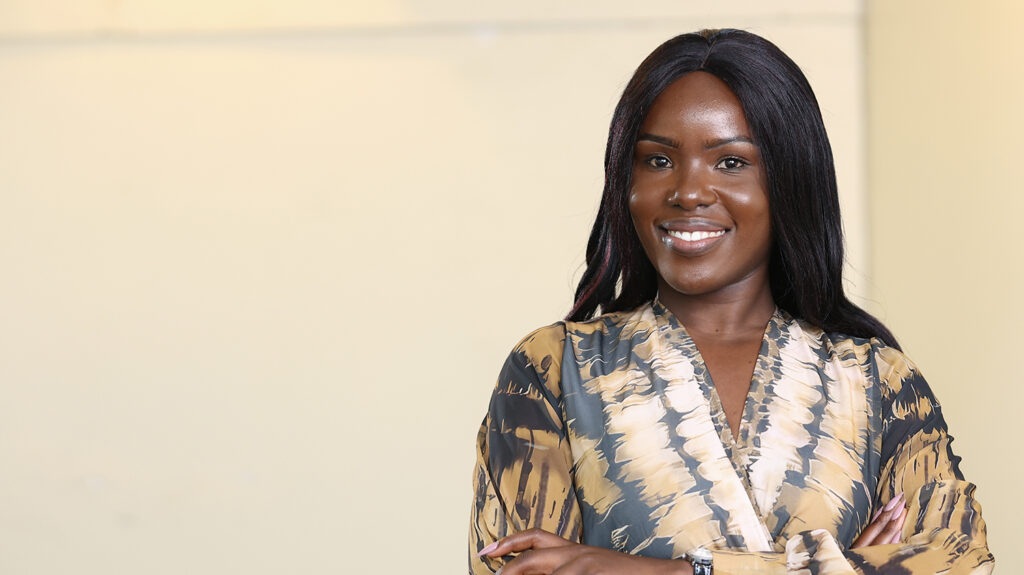 Lydia, standing confidently with her arms crossed.