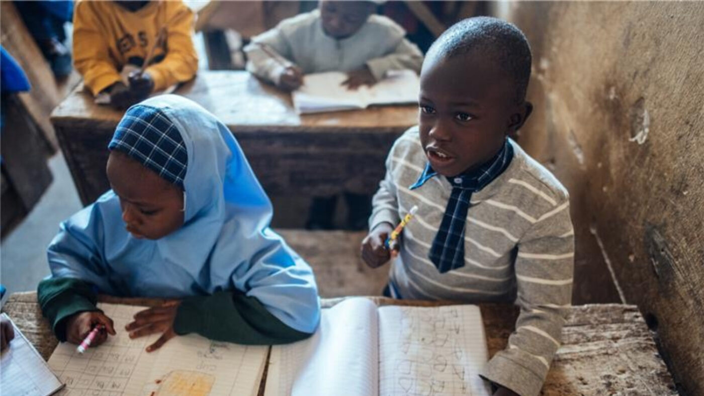 Muhammad sits at his desk at school.