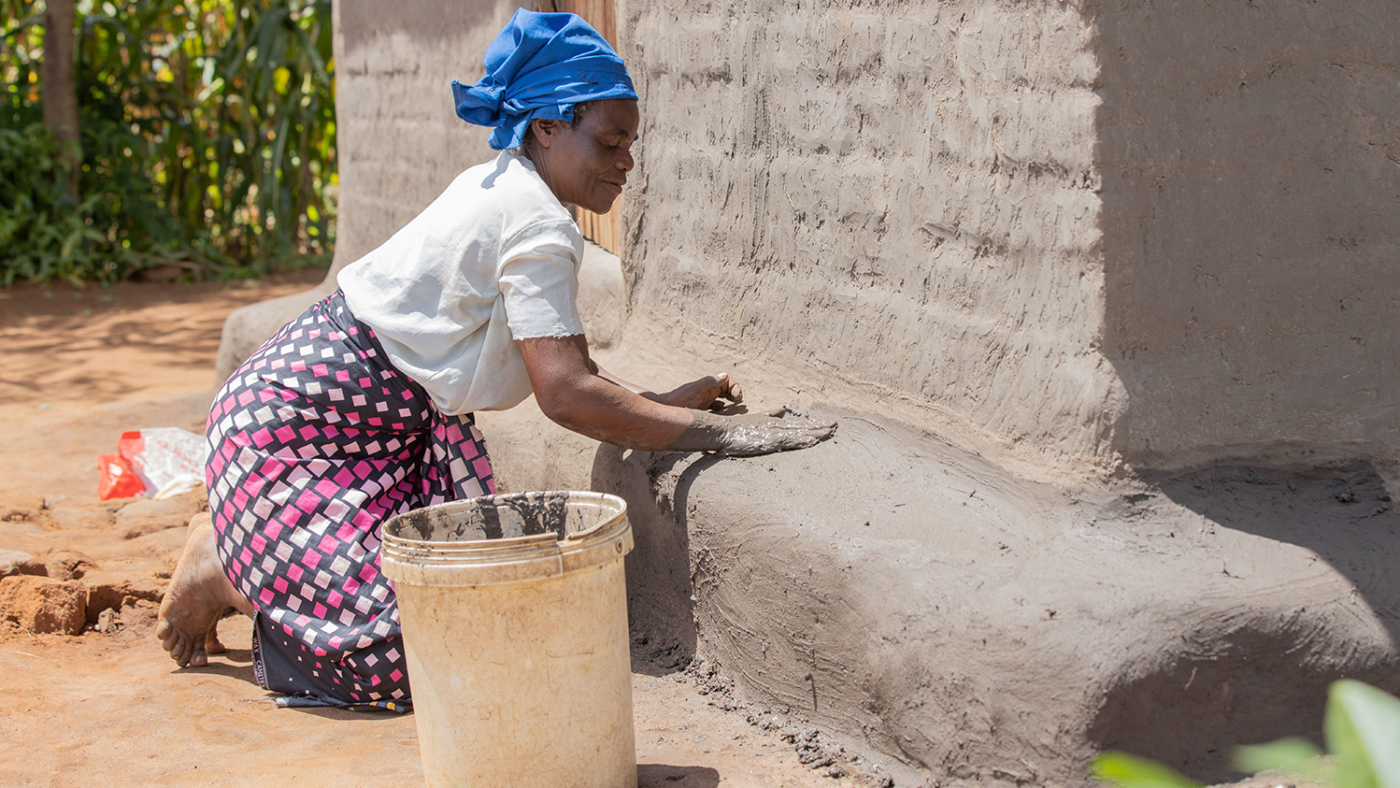 Margaret builds a clay step with her hands.