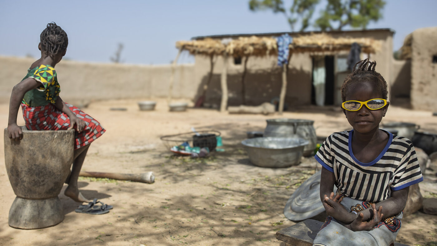 Six-year-old Kany pictured outside wearing yellow sunglasses.