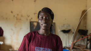 A woman stands in a knitting workshop.