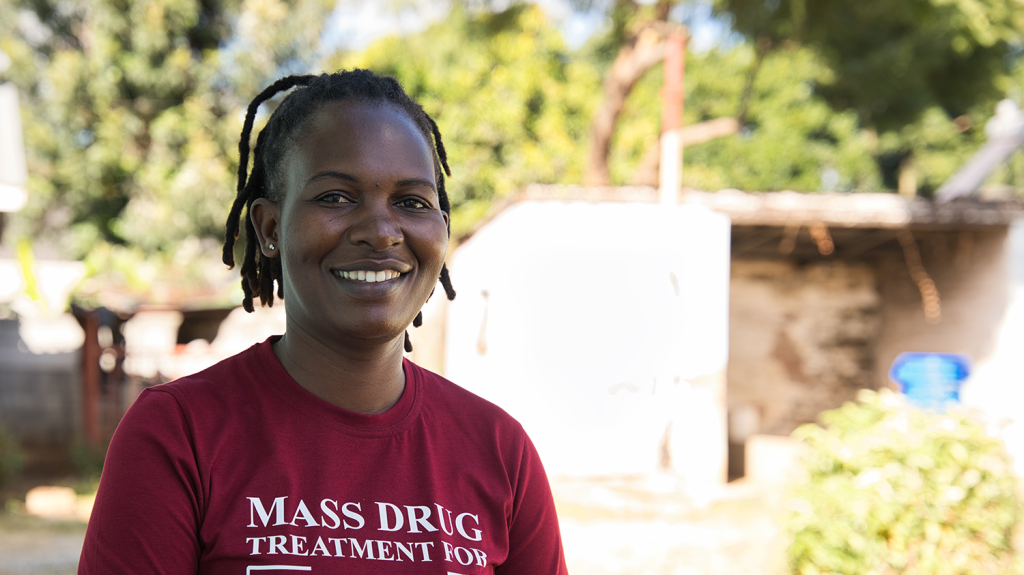 A woman smiles at the camera.