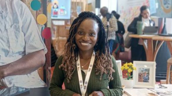 Caterina smiles while standing in an exhibition space at the Global Data Festival.