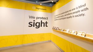 A wall featuring Sightsavers branding.